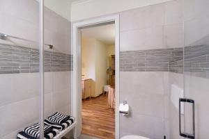 a bathroom with a shower with a glass door at Romantikzimmer in Striesen in Dresden