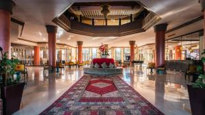 a lobby with a red couch in the middle of a building at Zalagh Kasbah Hotel & Spa in Marrakesh +123 photos
