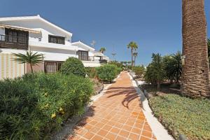 a brick walkway in front of a white house at Adelfa Golf in San Miguel de Abona