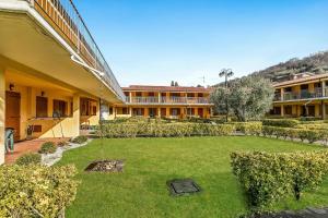 a courtyard of a building with a large yard at Residence La Perla with Shared Pool in Monte Isola +44 photos