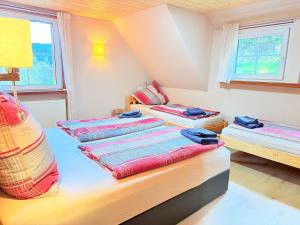 a room with three beds in it at Schwarzwaldhaus Zwink Ferienhaus in Enzklösterle