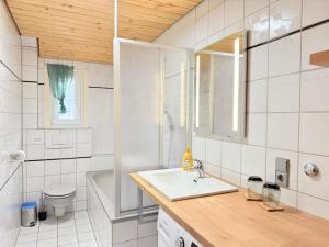 a bathroom with a sink and a toilet and a tub at Schwarzwaldhaus Zwink Ferienhaus in Enzklösterle +102 photos