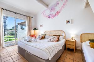 a bedroom with a bed and a window at Hotel La Tramontane in Saintes-Maries-de-la-Mer +49 photos