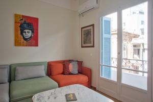 a living room with a couch and a window at Lovely, central, private balconies, roof garden! - EP7 in Athens
