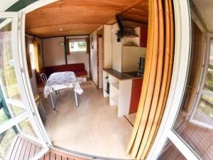 an internal view of a tiny house with a table at Camping Onlycamp l'Astrée in Bourg-Argental