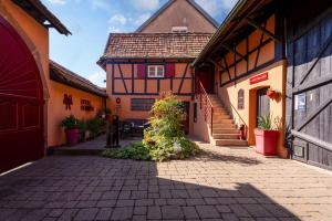 a courtyard of a building with a house at La Cour Des Amis in Vendenheim