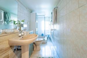a bathroom with a sink and a toilet at La Cour Des Amis in Vendenheim