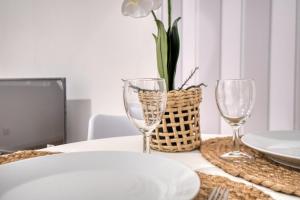a table with a white plate and two wine glasses at L'intemporel in Périgueux +11 photos