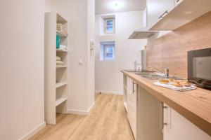 a kitchen with a sink and a counter top at L'intemporel in Périgueux