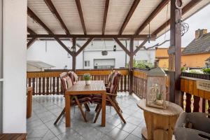 a patio with a table and chairs on a deck at Familienhaus mit riesigem Garten in Arnsdorf