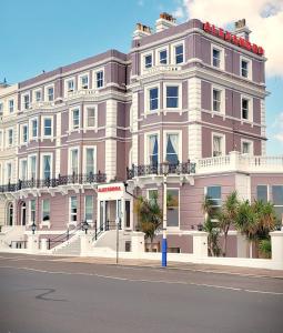 a large pink building on the side of a street at Alexandra Hotel in Eastbourne