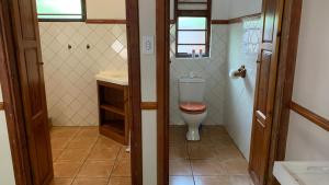 a bathroom with a toilet and a sink at Phumulani Lodge Kameeldrift in Pretoria