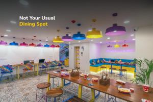 a restaurant with a table and chairs and a play room at goSTOPS Plus Katra in Katra