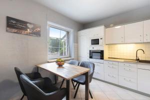 a kitchen with a wooden table and chairs at Fewo am Wasser 2 in Groß Lindow