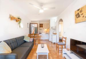 a living room with a couch and a table at Complejo turístico Menorca SOL ISLA in Arenal d'en Castell