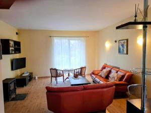 a living room with a couch and a table at 109m2 -Apartment Luiza 1- NEW Cottage in Klaipėda