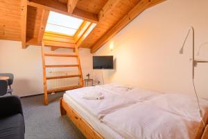 a bedroom with a bed in a room with a ladder at Haus Seewind Warnemünde in Rostock