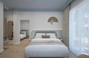 a bedroom with a large bed and a large window at Almara Green Hotel in Rimini +17 photos