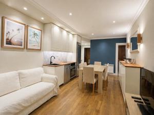 a living room with a white couch and a table at Biescas Suites in Biescas