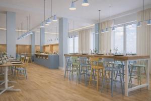a rendering of a restaurant with tables and chairs at Almara Green Hotel in Rimini