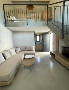 a living room with a couch and a staircase at Villa Relax in Kallithea Halkidikis