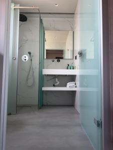 a bathroom with a shower and a sink and a mirror at Villa Relax in Kallithea Halkidikis
