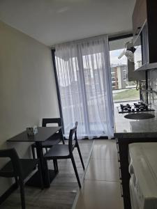 a kitchen and dining room with a table and a stove at Loft Tepe Hotel in Dikmen