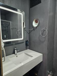 a bathroom with a white sink and a mirror at Loft Tepe Hotel in Dikmen