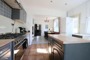 a kitchen with a stove and a counter top at Suffolk Coast Townhouse in Pakefield