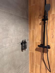 a bathroom with a shower with two bottles on the wall at Kutnowska Perła in Kutno +21 photos