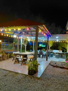 a patio with a picnic table and lights at night at Raniah homestay in Kuching