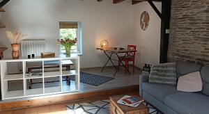 a living room with a couch and a table at L'Échappée en Sandales in La Gacilly +27 photos