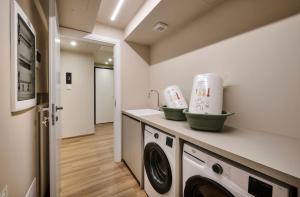 a laundry room with a washer and dryer at Monolocale 3 - viale Turati, Lecco in Milan +13 photos