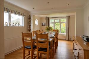 a kitchen and dining room with a table and chairs at White Sands in Croyde