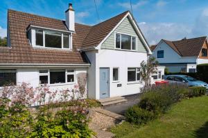a white house with a brown roof at White Sands in Croyde