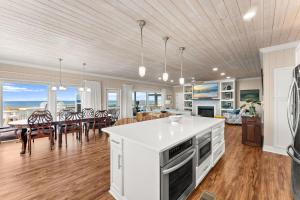a kitchen and living room with a table and chairs at Pet Friendly Beachfront Home - Casa Bella Del Sol in Cape San Blas