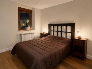 a bedroom with a large bed and a window at Biescas Suites in Biescas