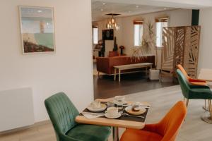 a dining room with a table and chairs at Kyriad Quimper Sud in Quimper