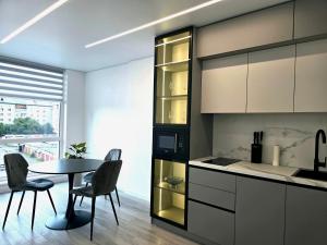 a kitchen with a table and a table and chairs at Belvedere Apart, parking in Ivano-Frankivsk