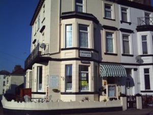 a large white building on the corner of a street at The Chequers in Great Yarmouth