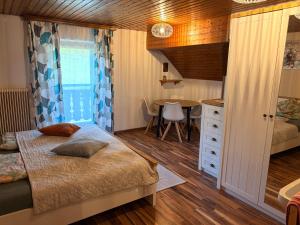 a small bedroom with a bed and a table at Wagnermoosgut in Bad Ischl