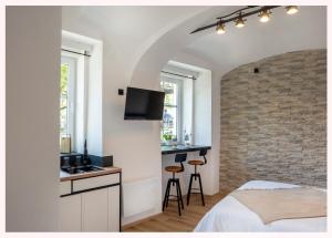 a bedroom with a bed and a kitchen with a counter at The 1826 Residence in Ljubljana