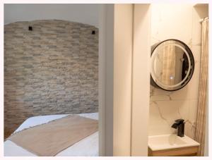 a bedroom with a brick wall and a mirror at The 1826 Residence in Ljubljana +43 photos
