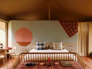 a bedroom with a bed and a table at Camp Canoe in Franschhoek