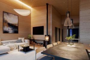 a living room with a couch and a table at TAHKO LAKESIDE VILLA D 3 in Tahkovuori