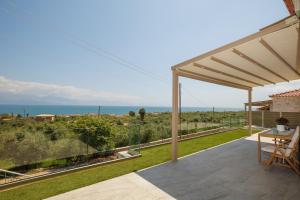 a patio with a view of the ocean at Petra & Thea Chrani Villas in Chrani