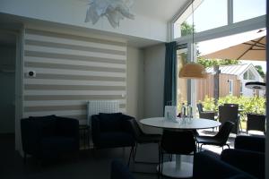 a dining room with a table and chairs at CampingHotel Renesse in Renesse