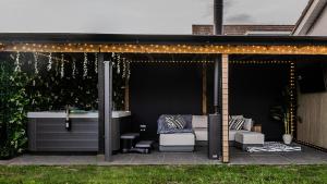 a gazebo with lights on it in a yard at Sun Set House With Hot Tub in Witchford