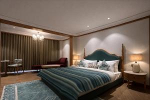 a bedroom with a large bed with a green headboard at AB's Abode-A Boutique Hotel in Mussoorie