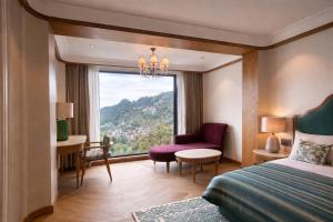 a hotel room with a bed and a window at AB's Abode-A Boutique Hotel in Mussoorie